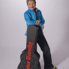 Photo of Sister Dorothy in casual wear standing with acoustic guitar case