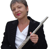 Photo of Sister Dorothy in a suit, standing, with flute