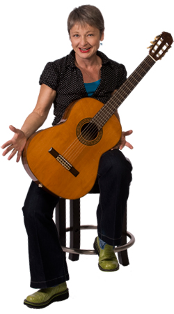 Photo of Sister Dorothy in casual wear sitting on stool with acoustic guitar