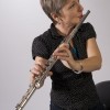 Photo of Sister Dorothy in casual wear, standing, with flute